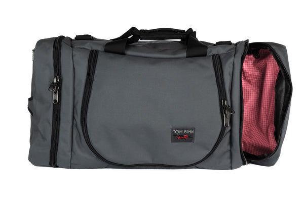 A Nebulous Grey (medium grey) Ballistic Aeronaut 45 with the end pocket open showing the Sakura (pale pink) Halcyon.